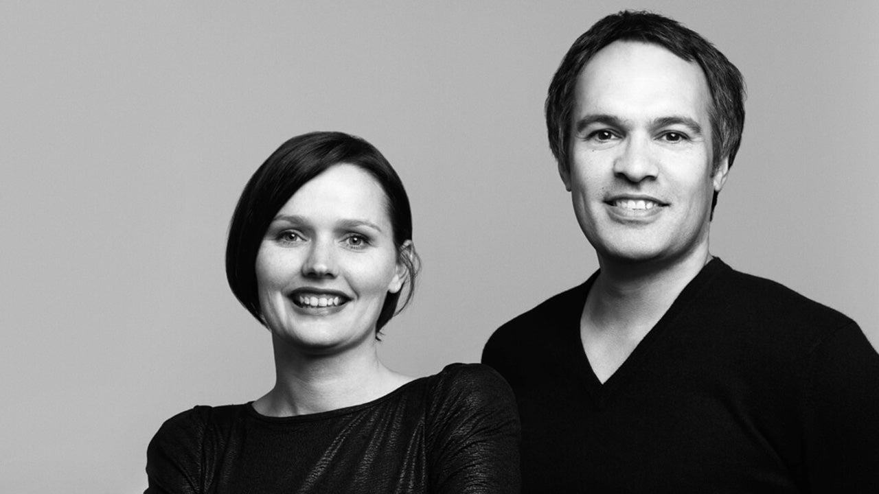 Black and white portrait of Carl and Belinda Keeley against a plain background